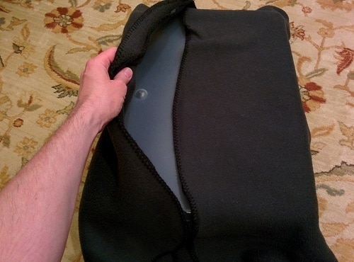 making-cat-hammock Hand coveres plastic storage bin with black blanket.